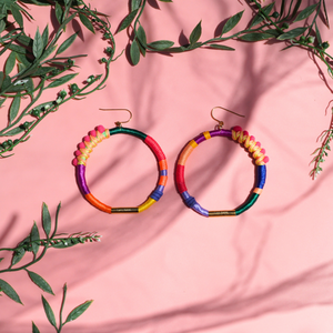 Handmade colourful hoop earrings wrapped in vibrant fibre threads, featuring unique woven details. Lightweight and comfortable statement jewellery. perfect for bold fashion lovers. 