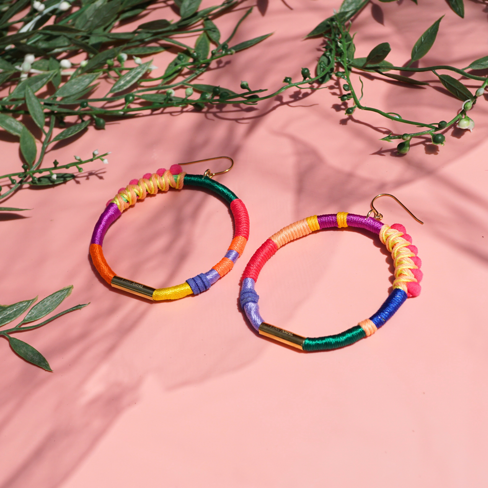 Handmade colourful hoop earrings wrapped in vibrant fibre threads, featuring unique woven details. Lightweight and comfortable statement jewellery. perfect for bold fashion lovers. 