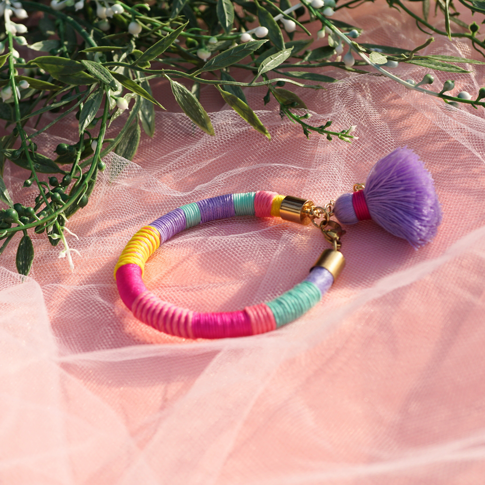 Handmade tassel bracelet crafted from vibrant coloured cords, designed to be lightweight and comfortable.