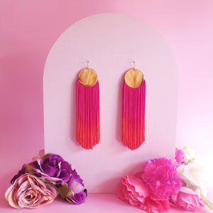 Hand-dyed pink and orange ombre tassel earrings with gold-plated round pendants, featuring a bold, vibrant, and elegant design. Lightweight and eye-catching, perfect for statement styling.