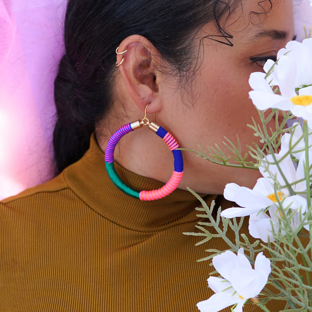 Model wearing Love Astrid's Pepa 2.0 statement hoop earrings – bold, colorful, handcrafted jewellery with gold-plated hooks, perfect for unique and vibrant style