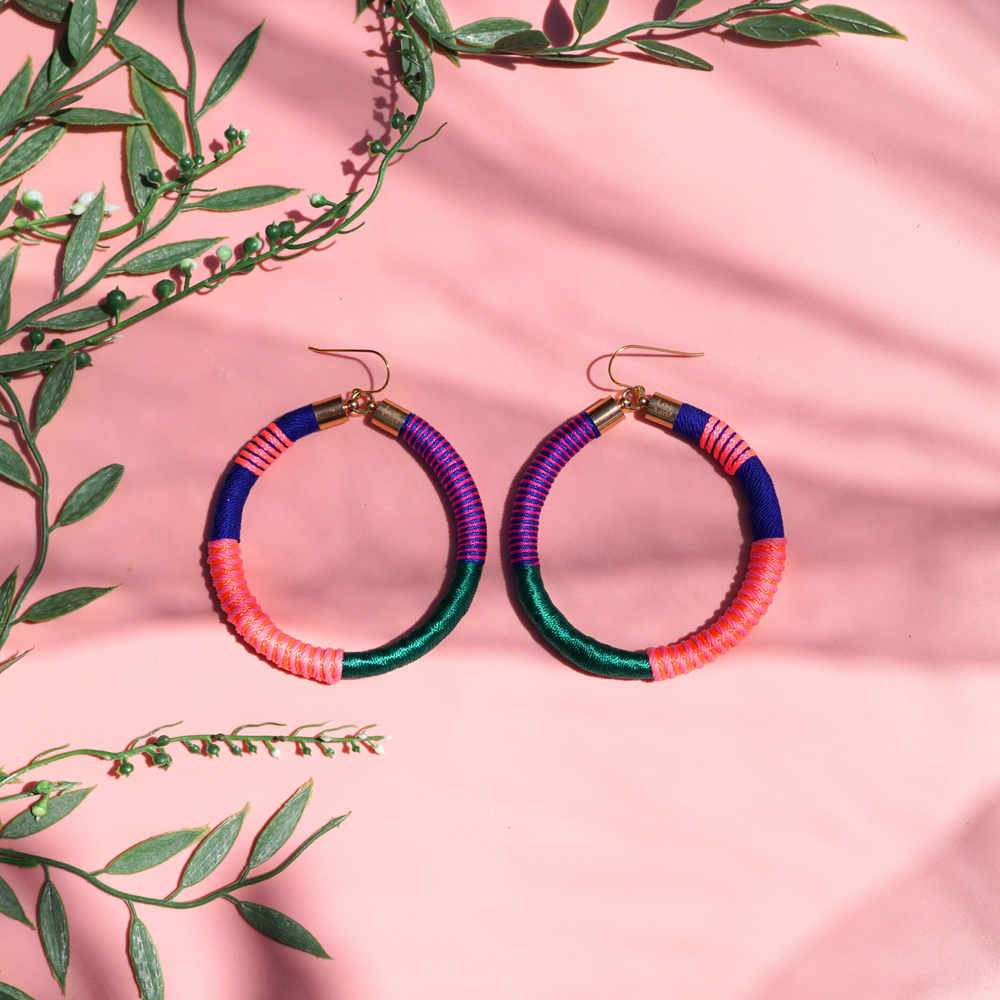 Colourful bold hoops earrings wrapped in a vibrant combination of emerald green, navy blue, orange, peach, and pink for a striking, vibrant and bold look.