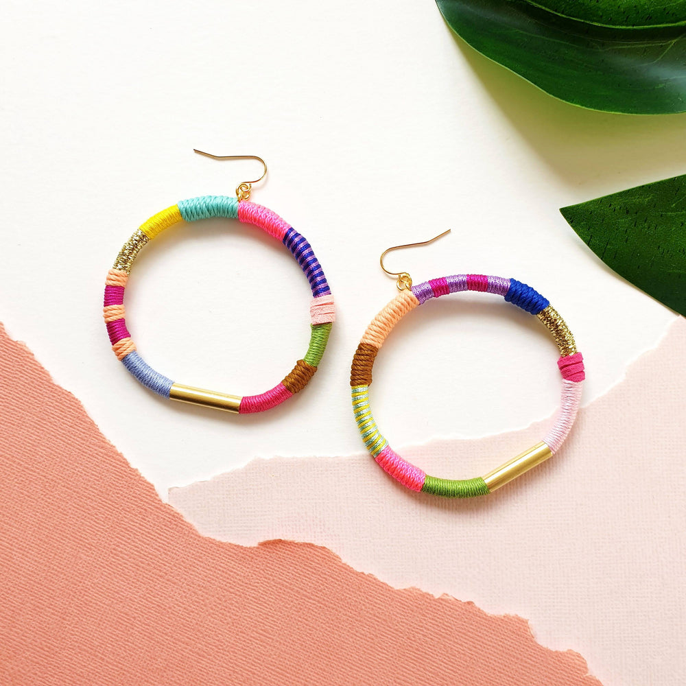 Colourful hoop earrings wrapped in vibrant, bold colours, featuring hypoallergenic gold-plated brass earring hooks 