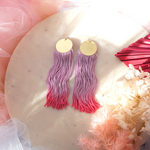 Hand-dyed purple-pink ombre tassel earrings with a gold-plated pendant, featuring a vibrant, lightweight, and elegant design.
