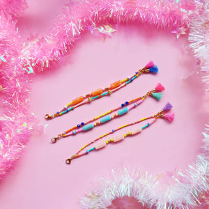 Display of green, peach, and orange beaded bracelets, showcasing their vibrant and colourful designs with a lively mix of beads and accents.