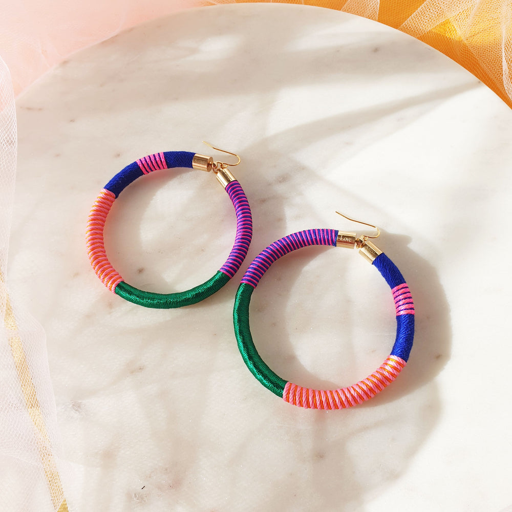 Colourful bold hoops earrings wrapped in a vibrant combination of emerald green, navy blue, orange, peach, and pink for a striking, vibrant and bold look.