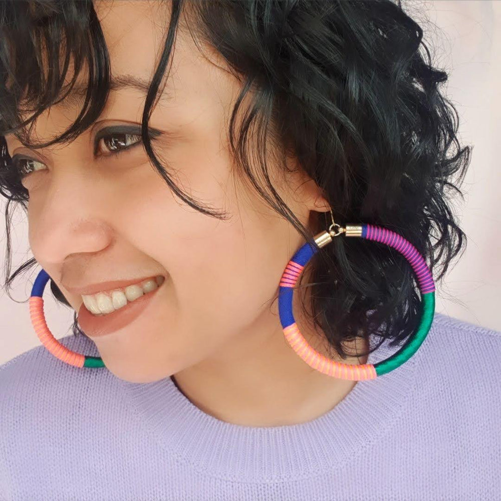 Model wearing Love Astrid's Pepa 2.0 statement hoop earrings – bold, colorful, handcrafted jewellery with gold-plated hooks, perfect for unique and vibrant style