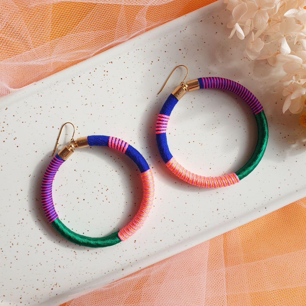 Colourful bold earrings wrapped in a vibrant combination of emerald green, navy blue, orange, peach, and pink for a striking, playful look.