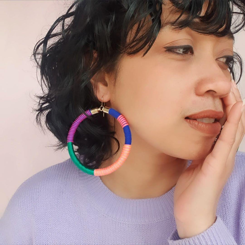 Model wearing Love Astrid's Pepa 2.0 statement hoop earrings – bold, colorful, handcrafted jewellery with gold-plated hooks, perfect for unique and vibrant style